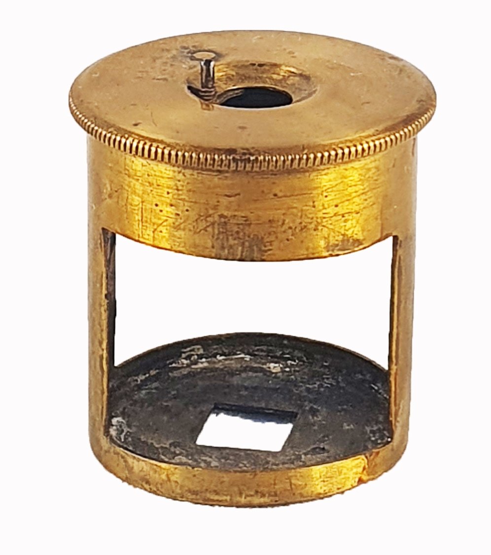 A gold metal object with a holeDescription automatically generated