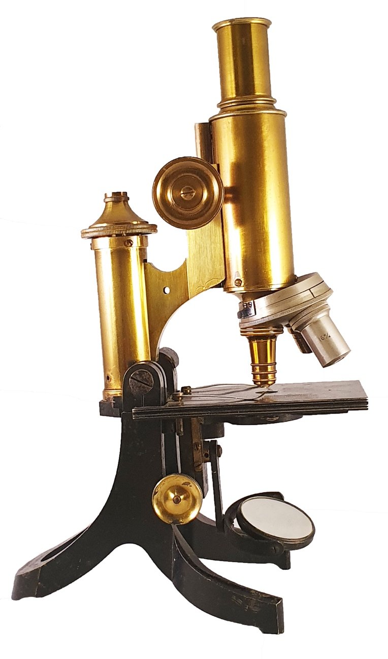 Microscope In 1900 A picture containing indoor, table, old, frontDescription automatically ...