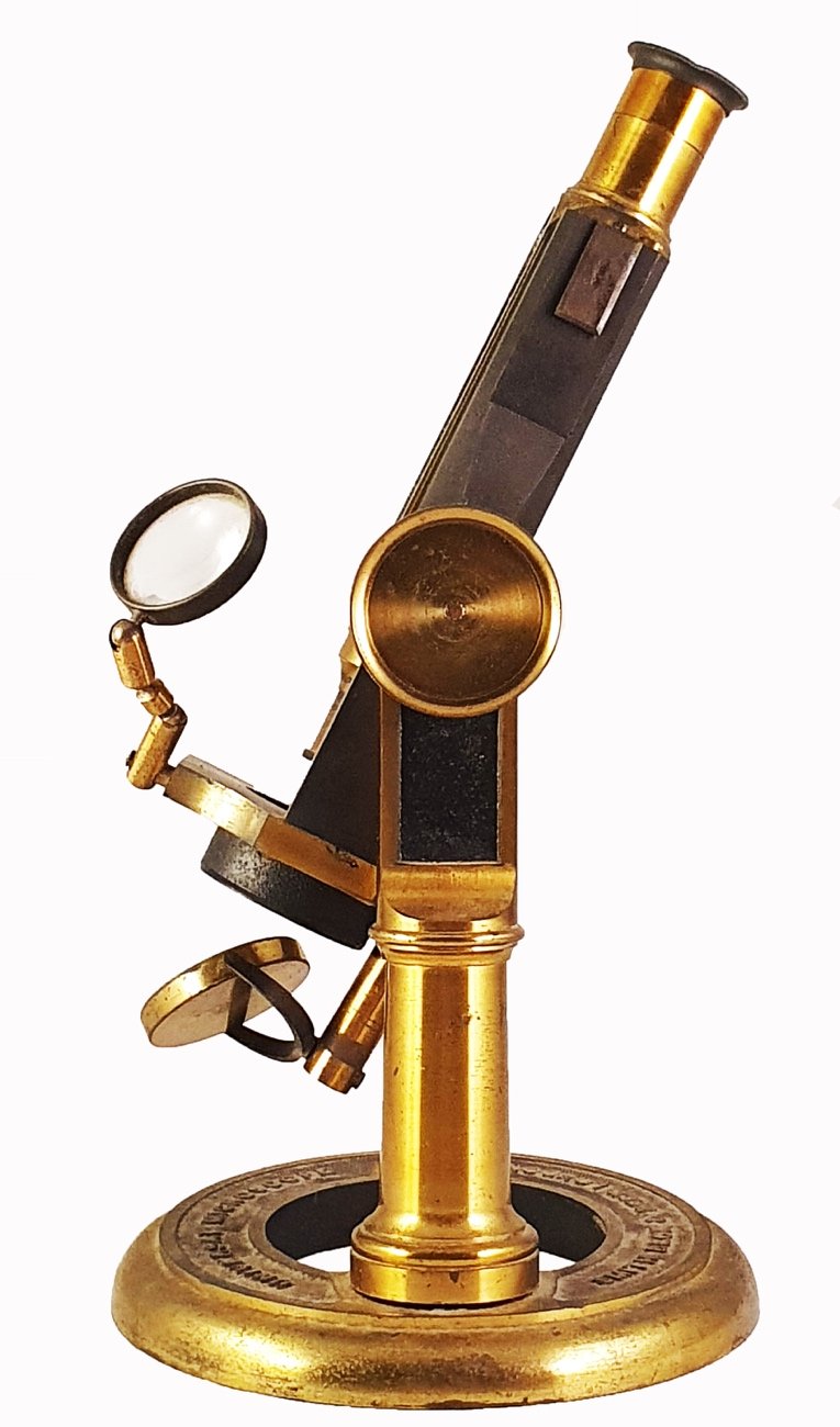 Smith Microscope A picture containing table, sitting, small, clockDescription ...