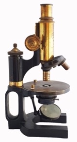 A picture containing indoor, table, old, sitting
Description automatically generated