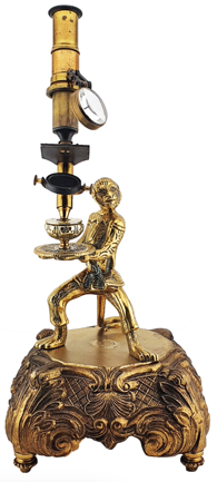 A gold statue of a person holding a tray
Description automatically generated