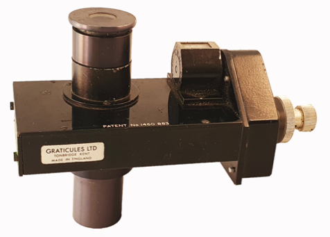 A black metal object with a white label
Description automatically generated