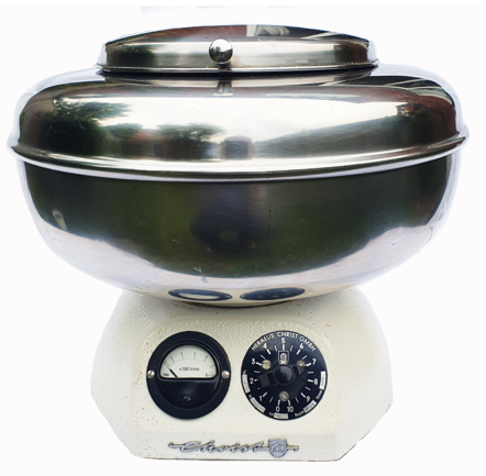 A silver bowl on a white and black scale
Description automatically generated