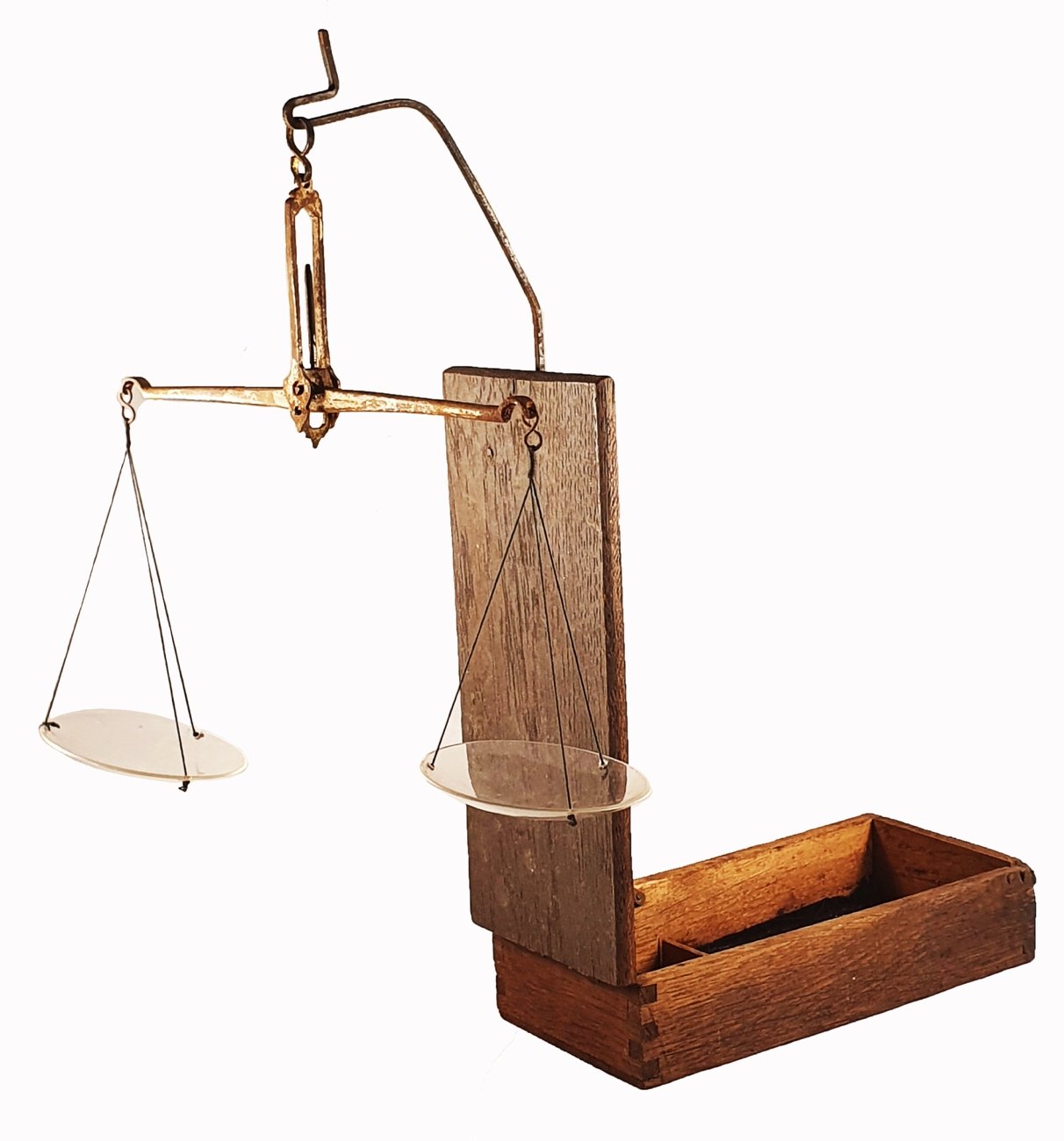 A balance scale with a wooden boxDescription automatically generated